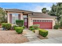 Inviting single-story home with well-maintained landscaping, shuttered windows, and a two-car garage at 3200 Ridgecliff St, Las Vegas, NV 89129