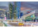 Vibrant city view featuring modern high-rise buildings, bustling street, and retail signage at 3722 Las Vegas Blvd # 2509, Las Vegas, NV 89158