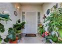 Inviting front porch featuring a decorative security door and an array of potted plants at 3913 Cutting Horse Ave, North Las Vegas, NV 89032