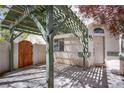 Charming courtyard featuring a wooden gate and overhead trellis at 3953 Broad Meadow Ct, Las Vegas, NV 89129