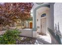Inviting front entrance with a covered walkway and mature landscaping at 3953 Broad Meadow Ct, Las Vegas, NV 89129