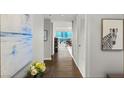 Hallway featuring dark hardwood floors, modern art, and bright city views at 4471 Dean Martin Dr # 1210, Las Vegas, NV 89103