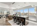 Modern kitchen with island, stainless steel appliances, bar stool seating and expansive city views at 4471 Dean Martin Dr # 1210, Las Vegas, NV 89103