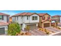 Exterior view of a two-story home featuring a tile roof and manicured landscaping at 5016 Kaslo Ave, Las Vegas, NV 89139