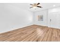 Bright living room with hardwood floors, a ceiling fan, and a window at 5060 Blue Rose St, North Las Vegas, NV 89081