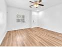 Bright living room with hardwood floors, a ceiling fan, and a window at 5060 Blue Rose St, North Las Vegas, NV 89081
