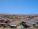 Community aerial showcasing the pool, rooftops, and scenic mountain views in the distance at 54 Mirage View Dr, Henderson, NV 89011