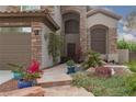 The front entrance features a secure ornamental metal gate and a beautifully manicured stone walkway at 5404 Ireland St, Las Vegas, NV 89149