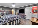 Nicely decorated bedroom featuring a large screen television and access to an en suite bathroom at 5424 Neosho St, Las Vegas, NV 89120