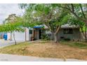 Single-story home with a two-car garage and xeriscaping in the front yard at 5600 W Bartlett Ave, Las Vegas, NV 89108