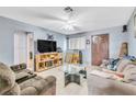 Inviting living room with tile floors, ceiling fan, and neutral paint at 5600 W Bartlett Ave, Las Vegas, NV 89108