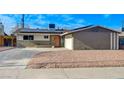 Charming exterior view of single story home featuring solar panels and low maintenance rock yard at 5904 Apple Valley Ln, Las Vegas, NV 89108