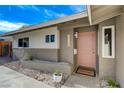 Single-story home featuring a pink front door, modern landscaping, and a 'Welcome' mat at 5904 Apple Valley Ln, Las Vegas, NV 89108