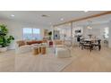 Open concept living room and dining area with modern decor and lots of natural light at 5904 Apple Valley Ln, Las Vegas, NV 89108