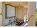 Relaxing front porch area with seating and an overhead light fixture at 6032 S Pioneer Way, Las Vegas, NV 89113