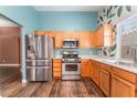 Bright kitchen with stainless steel appliances, light wood cabinets and eat in dining area at 6056 Flowering Plum Ave, Las Vegas, NV 89142