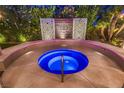 Inviting hot tub with a unique lotus decoration and artistic privacy screen and surrounded by lush plants for ultimate relaxation at 6316 Bluejay Way, Las Vegas, NV 89146
