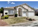 Well-maintained single-story home with a three-car garage and desert-friendly front yard landscaping at 8084 Black Orchid Ave, Las Vegas, NV 89131