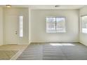 Bright living room with neutral paint, large windows, and a combination tile and carpet flooring at 8084 Black Orchid Ave, Las Vegas, NV 89131