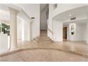 Spacious foyer with tile flooring, decorative columns, and a staircase leading to the second floor at 8117 Horizon Lake Dr, Las Vegas, NV 89128