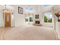 Bright living room with soaring ceilings, a fireplace, and multiple large windows at 8117 Horizon Lake Dr, Las Vegas, NV 89128