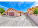 Spacious three-car garage with ample driveway space and secure gate for added privacy and convenience at 902 Little Raven St, Henderson, NV 89002