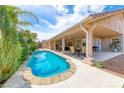 Inviting backyard featuring a private pool, covered patio, and lush landscaping, perfect for outdoor entertaining at 902 Little Raven St, Henderson, NV 89002