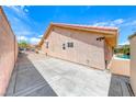 Expansive side yard with concrete slab, leading to the backyard, offering ample space for potential projects at 902 Little Raven St, Henderson, NV 89002