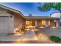 Inviting front entrance with manicured landscaping and walkway lights at 6316 Bluejay Way, Las Vegas, NV 89146