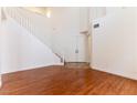 Inviting foyer with hardwood floors, a staircase, and double-door entrance at 10381 Walking View Ct, Las Vegas, NV 89135