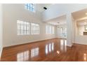 Bright living room featuring hardwood floors, high ceilings, and large windows at 10381 Walking View Ct, Las Vegas, NV 89135
