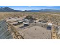 Expansive aerial view of ranch featuring horse facilities, outbuildings, and a charming home nestled in a desert landscape at 11875 Maggie Ave, Las Vegas, NV 89166