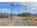 View down the long gravel driveway to the Nevada home, boasting privacy and seclusion at 11875 Maggie Ave, Las Vegas, NV 89166
