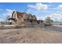 Charming two-story ranch-style home featuring a balcony and porch areas with natural stone accents in a rural setting at 11875 Maggie Ave, Las Vegas, NV 89166
