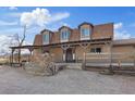 Inviting ranch-style home boasting a covered porch, wagon wheel decor, and a rustic split rail fence at 11875 Maggie Ave, Las Vegas, NV 89166