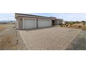 Paver driveway leads to the three-car garage, enhances the curb appeal of this home at 3660 Stirrup, Pahrump, NV 89048