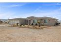 Single story house with a 3-car garage and desert landscaping offers a welcoming home at 3660 Stirrup, Pahrump, NV 89048