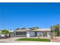 Cozy single-story home with desert landscaping, a green lawn, and a well-maintained exterior at 4012 Mira Ln, Las Vegas, NV 89108