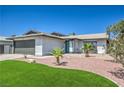 Inviting single-story home with a manicured lawn, desert landscaping, and a freshly painted exterior at 4012 Mira Ln, Las Vegas, NV 89108