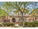 Charming two-story home with iron fence, desert landscaping, and covered entry at 10085 S Riley St, Las Vegas, NV 89178