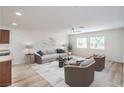 Spacious living room with natural light, ceiling fan, and open layout at 10085 S Riley St, Las Vegas, NV 89178