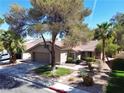 Beautiful home with a well-manicured lawn, mature trees, and a spacious driveway at 2022 Big Bend Way, Henderson, NV 89074