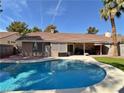 Inviting backyard featuring a large swimming pool, covered patio, and well-maintained landscaping at 2022 Big Bend Way, Henderson, NV 89074