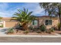 Inviting single-story home with desert landscaping, covered entry and attached two-car garage at 2489 Black River Falls Dr, Henderson, NV 89044