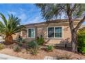 Inviting single-story home with desert landscaping, covered entry and attached two-car garage at 2489 Black River Falls Dr, Henderson, NV 89044
