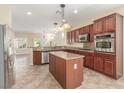 Spacious kitchen with granite countertops, stainless steel appliances, and a large island for entertaining at 2489 Black River Falls Dr, Henderson, NV 89044