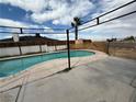 Backyard swimming pool with a concrete patio under a metal pergola with views of the surroundings at 4186 Toronto Cir, Las Vegas, NV 89121