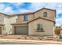 Inviting two-story home showcasing a brick driveway, two-car garage, manicured landscaping and a tile roof at 89 Oratorio Dr, Henderson, NV 89015