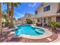 Sparkling pool with inviting step-down entry surrounded by lush landscaping in a private backyard oasis at 8942 Galena Crossing St, Las Vegas, NV 89123