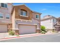 Charming two-story townhome with a two-car garage, neutral color palette, and inviting curb appeal at 9981 Sable Point St, Las Vegas, NV 89178
